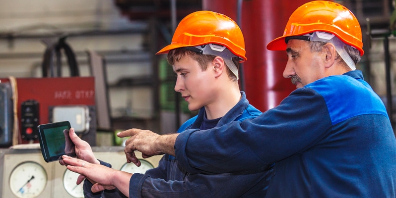 Project Manager assisting construction worker